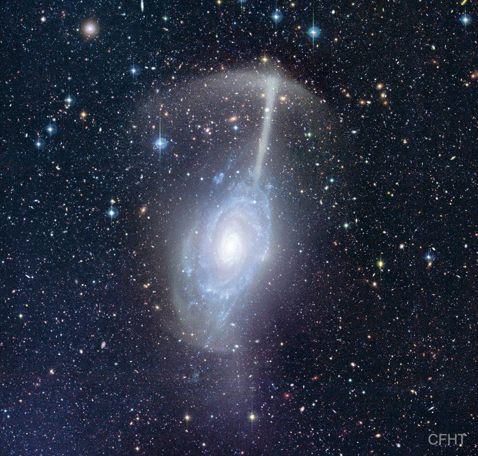 The featured image shows a galactic merger together
called the Umbrella Galaxy because the remnants of one 
galaxy have been left looking like an umbrella hovering 
over the other galaxy.
Please see the explanation for more detailed information.