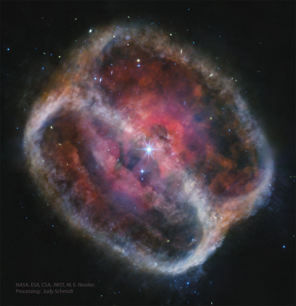 A starfield is dominated by a multi-coloured figure
8 in the middle, titled on a diagonal. The outsides 
of the nebula appear light coloured, while the inside shows
complex structure tinted red and purple. 
Please see the explanation for more detailed information.