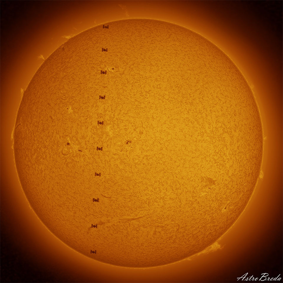 The Sun is pictured complete with active regions,
filaments, and prominences. Down the Sun's face is 
a series of silhouettes that are the International 
Space Station passing right in front. 
Please see the explanation for more detailed information.