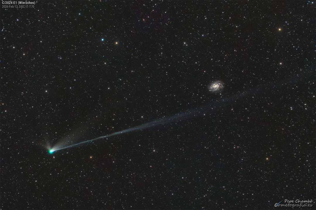 A star field shows a bright comet with its head
on the lower left and tails extending toward the upper
right. A background galaxy is visible on the far right.
Please see the explanation for more detailed information.