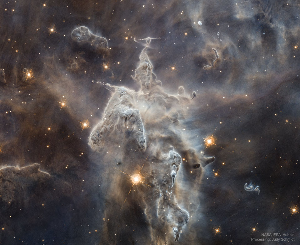 The featured image shows a large pillar of dust and
gas in the Carina Nebula. The pillar has many humps and 
several jets.
Please see the explanation for more detailed information.