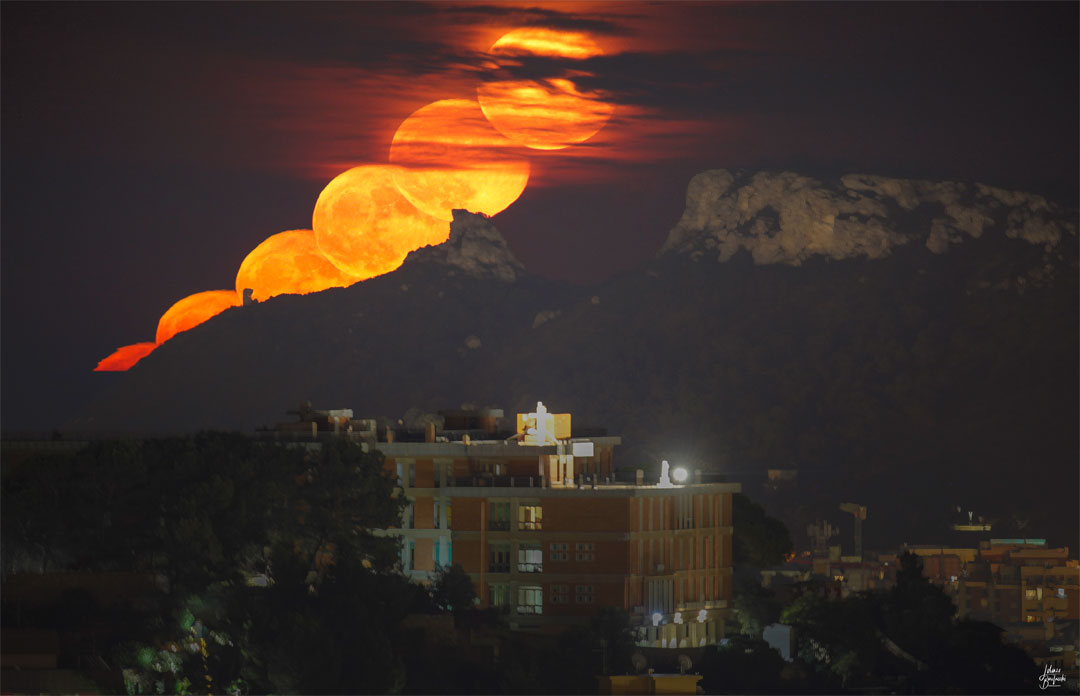 The featured image shows an orange moon rising beyond
picturesque mountains. 
Please see the explanation for more detailed information.