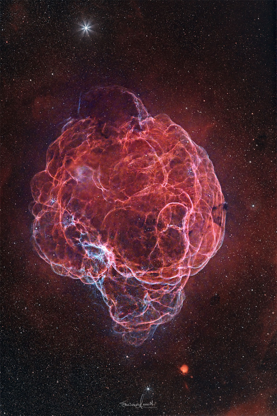 A starfield surrounds a giant red nebula. The nebula has so 
many winding filaments that it has been dubbed the Spaghetti Nebula.
Please see the explanation for more detailed information.