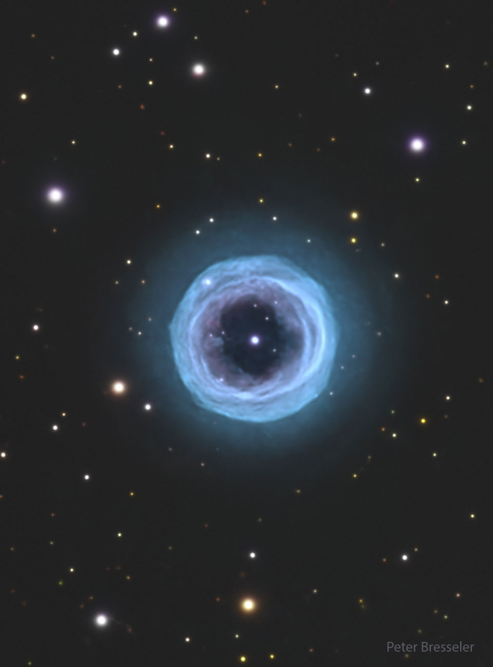 A starfield is shown with a large circular blue
ring in the centre. In the ring's centre is a bright
blue spot. 
Please see the explanation for more detailed information.