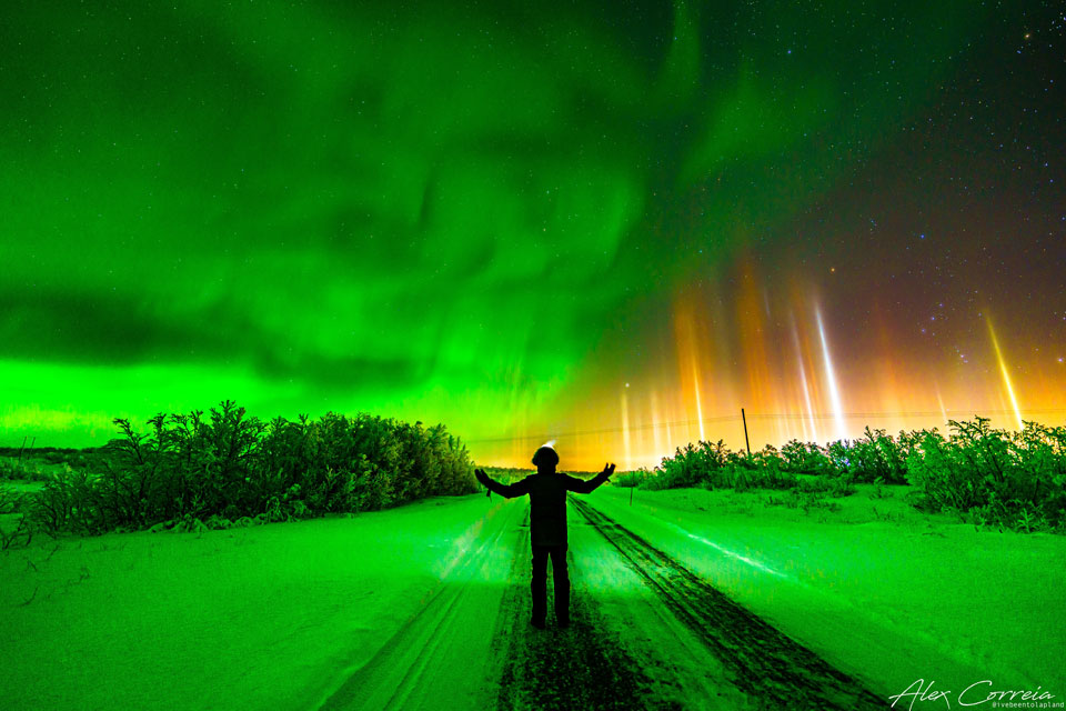 The featured image shows the photographer standing
beneath a night sky with green aurora on the left and colourful 
light pillars on the right. 
Please see the explanation for more detailed information.