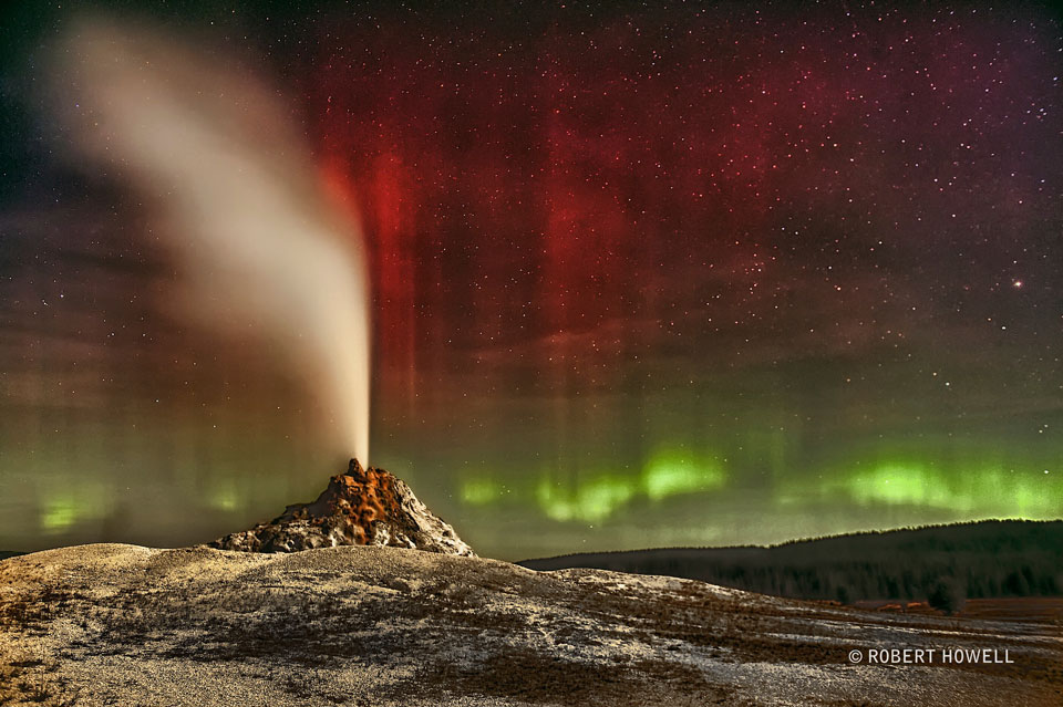 The featured image shows White Dome geyser erupting in Yellowstone
National Park with colourful aurora in the background. 
Please see the explanation for more detailed information.