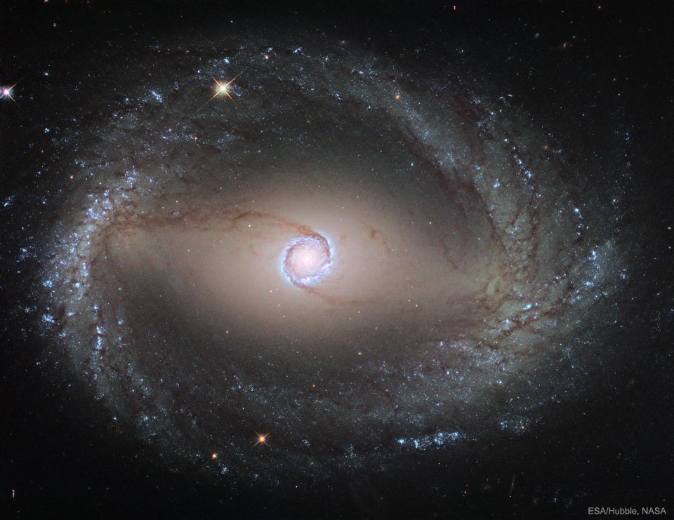The featured image shows the spiral galaxy
NGC 1512 as taken by the Hubble Space Telescope. 
The galaxy shows two rings surrounding its centre.
Please see the explanation for more detailed information.