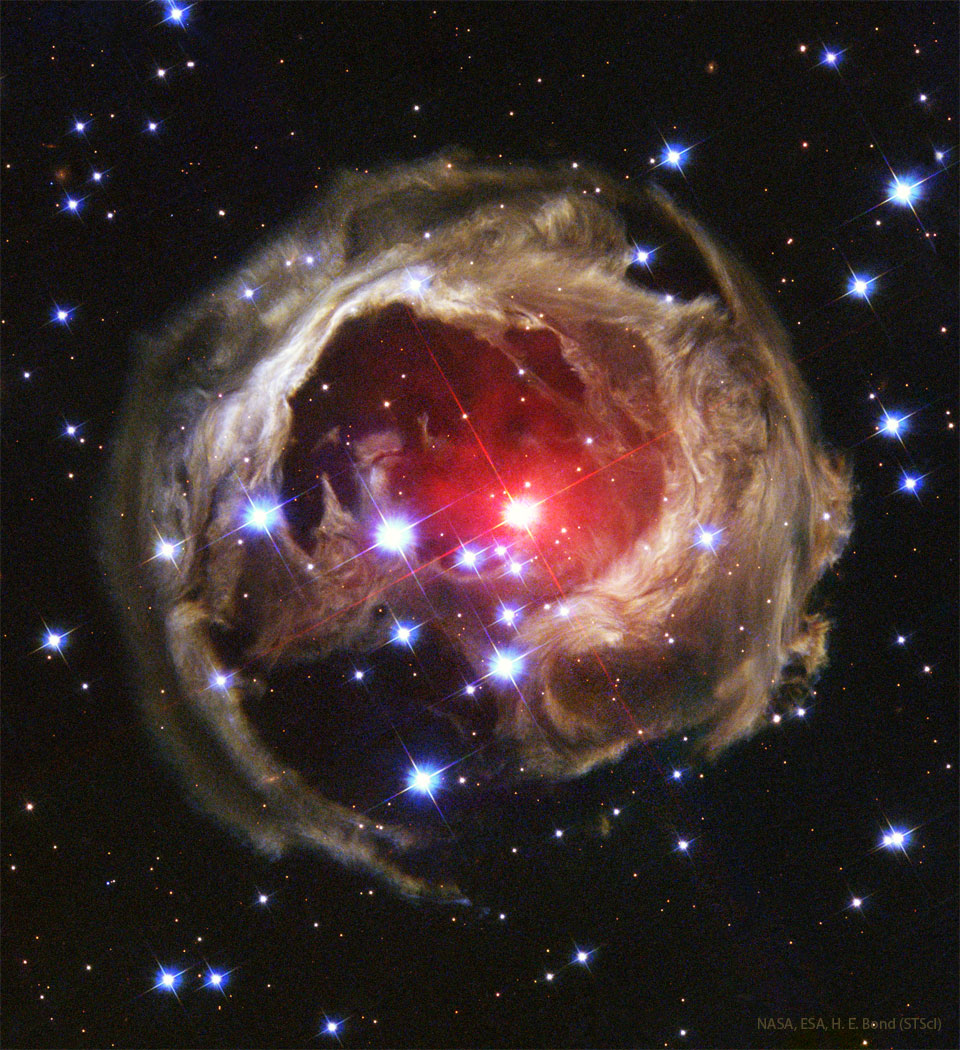 The featured image shows the unusual light
echo structure known as V838 Mon. The illuminated dust
is patchy and surrounds a bright red-coloured star.
Please see the explanation for more detailed information.