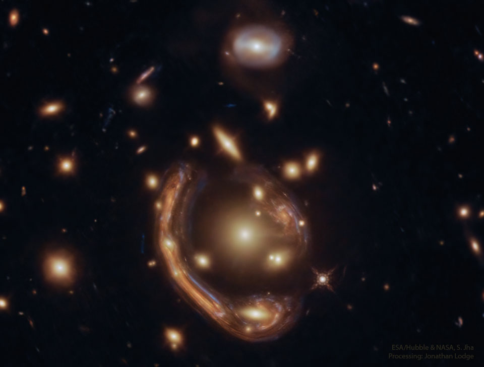 The featured image shows a distant galaxy distorted into 
a giant arc around the centre of a galaxy cluster by gravitational
lensing.
Please see the explanation for more detailed information.