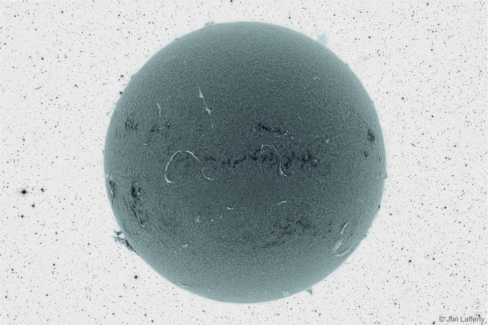 The featured image shows a dark ball covered with light
and dark markings in front of a colour-negative starfield 
Please see the explanation for more detailed information.