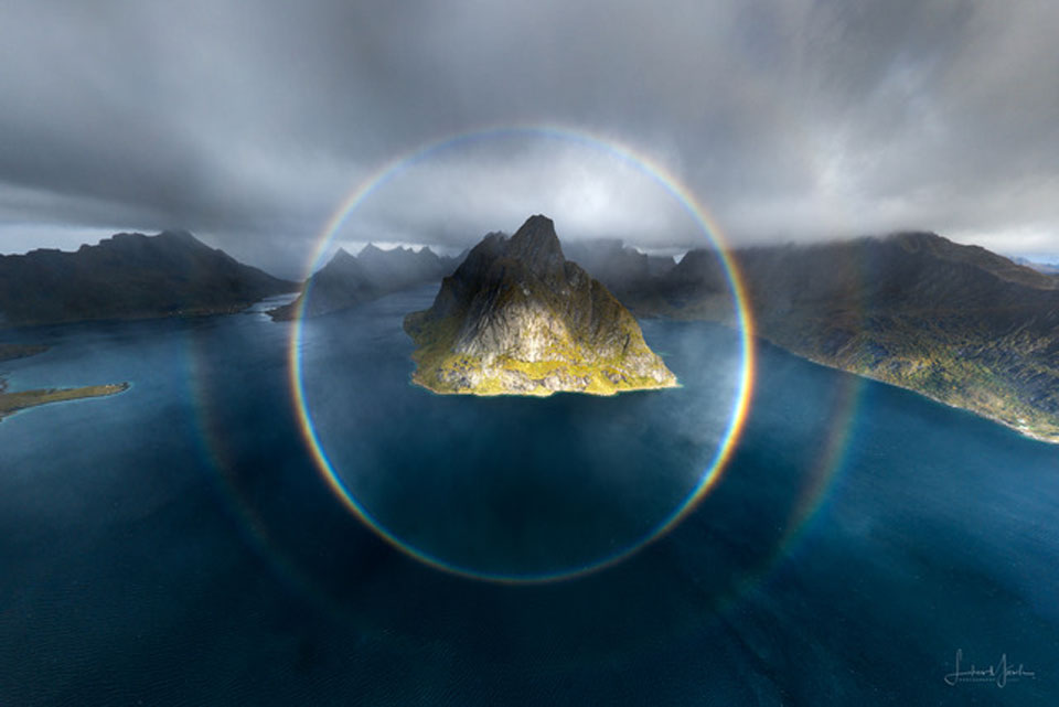 The featured image shows two complete circular rainbows
centred on a mountainous island. 
Please see the explanation for more detailed information.