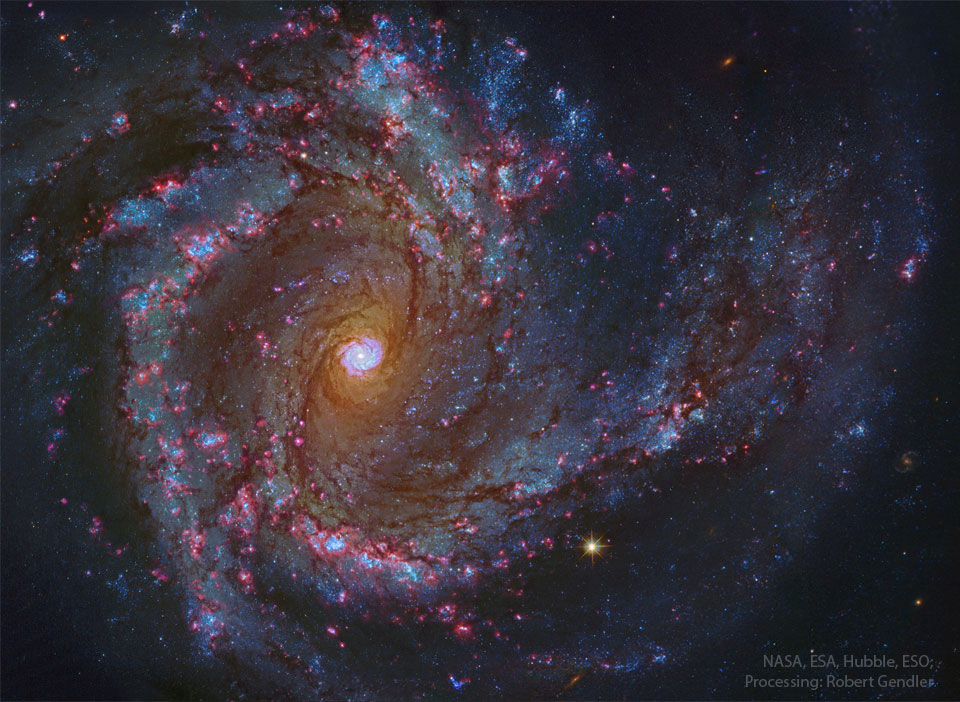 A sprawling spiral galaxy is shown in great detail.
This galaxy has blue spiral arms and a bright centre
that itself seems to look like a spiral galaxy.
Please see the explanation for more detailed information.