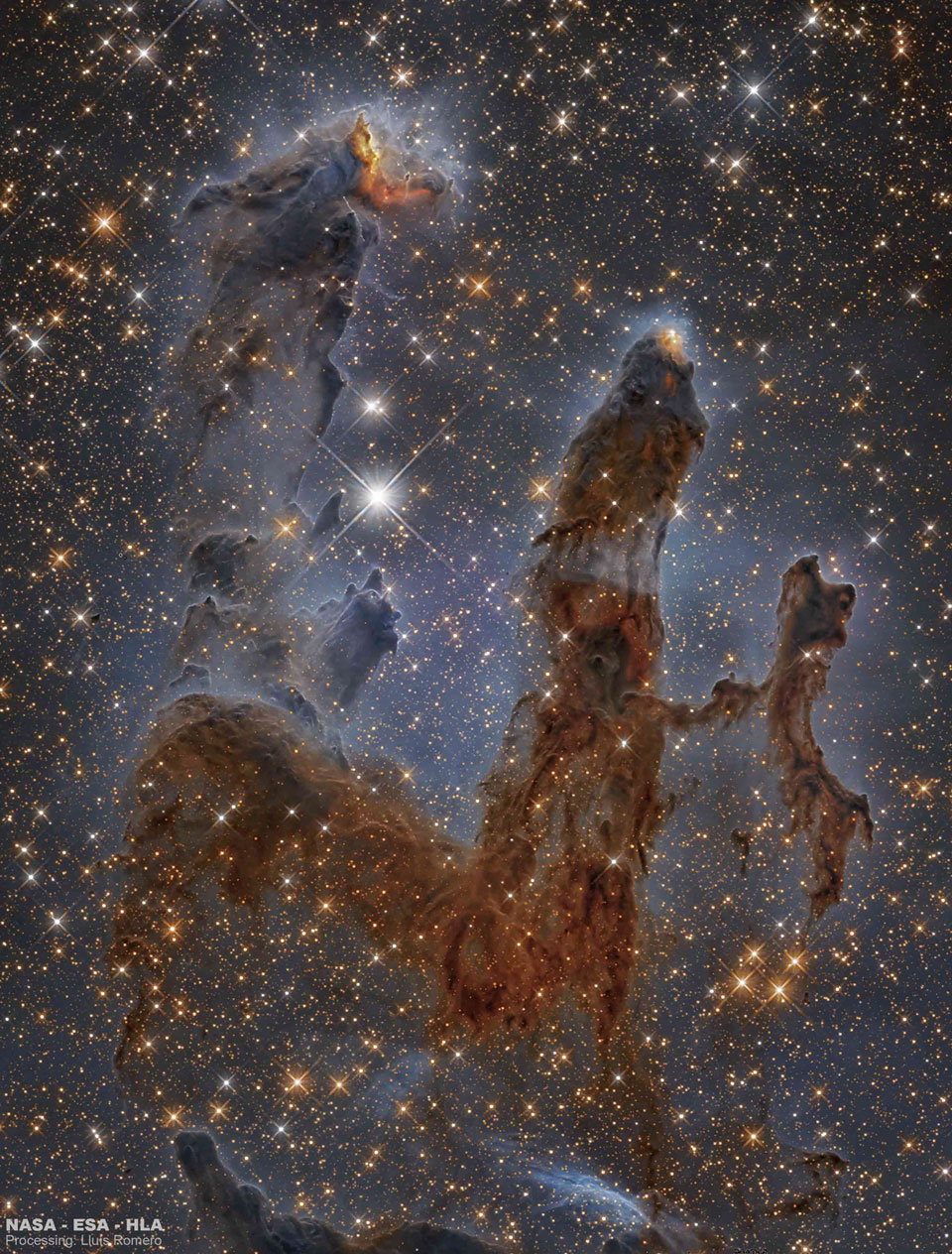 A starfield surrounds three large brown pillars
of dark dust. The pillars are shown vertically.
Please see the explanation for more detailed information.