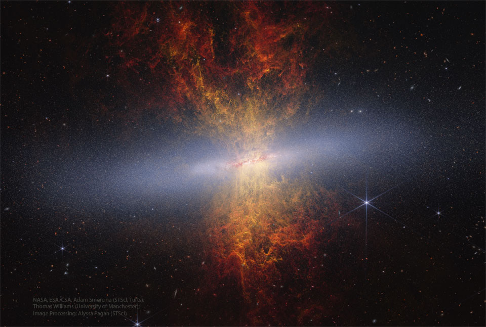A starfield surrounds an unusual object with 
a band of diffuse white crossing horizontally.
Emanating out from the band toward both the top
and the bottom of the frame is an orange and red
nebula.  
Please see the explanation for more detailed information.